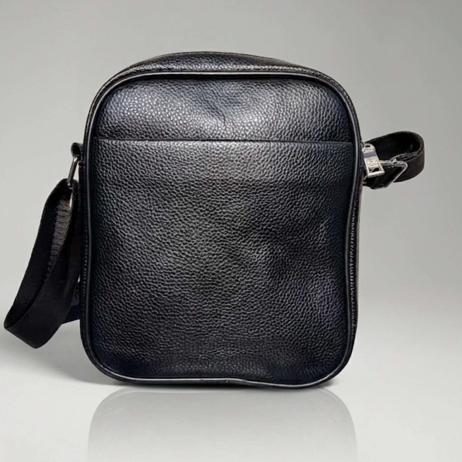 Black pebbled leather crossbody messenger bag with an adjustable strap.