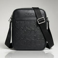 Coach black signature debossed leather crossbody bag with an adjustable strap.