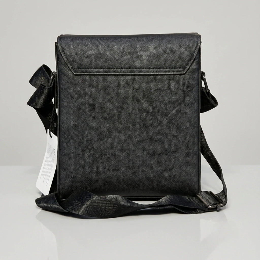 Coach black signature embossed flap messenger bag with metal push lock closure.
