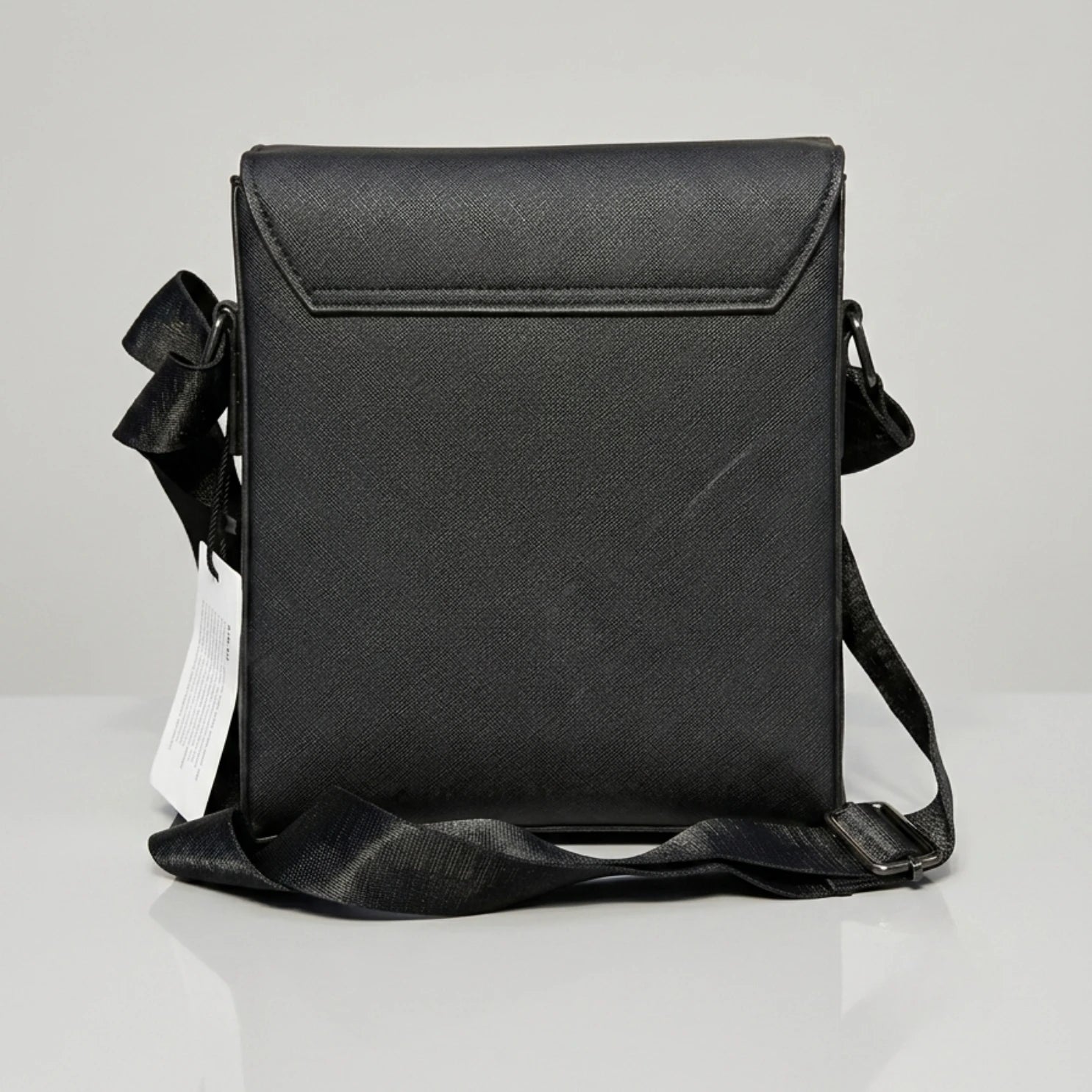Coach black signature embossed flap messenger bag with metal push lock closure.