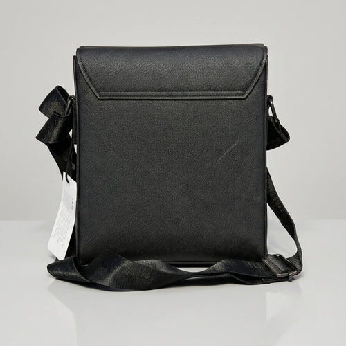 Coach black signature embossed flap messenger bag with metal push lock closure.
