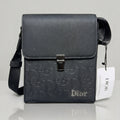 Dior black Oblique embossed flap messenger bag with metal push lock closure.