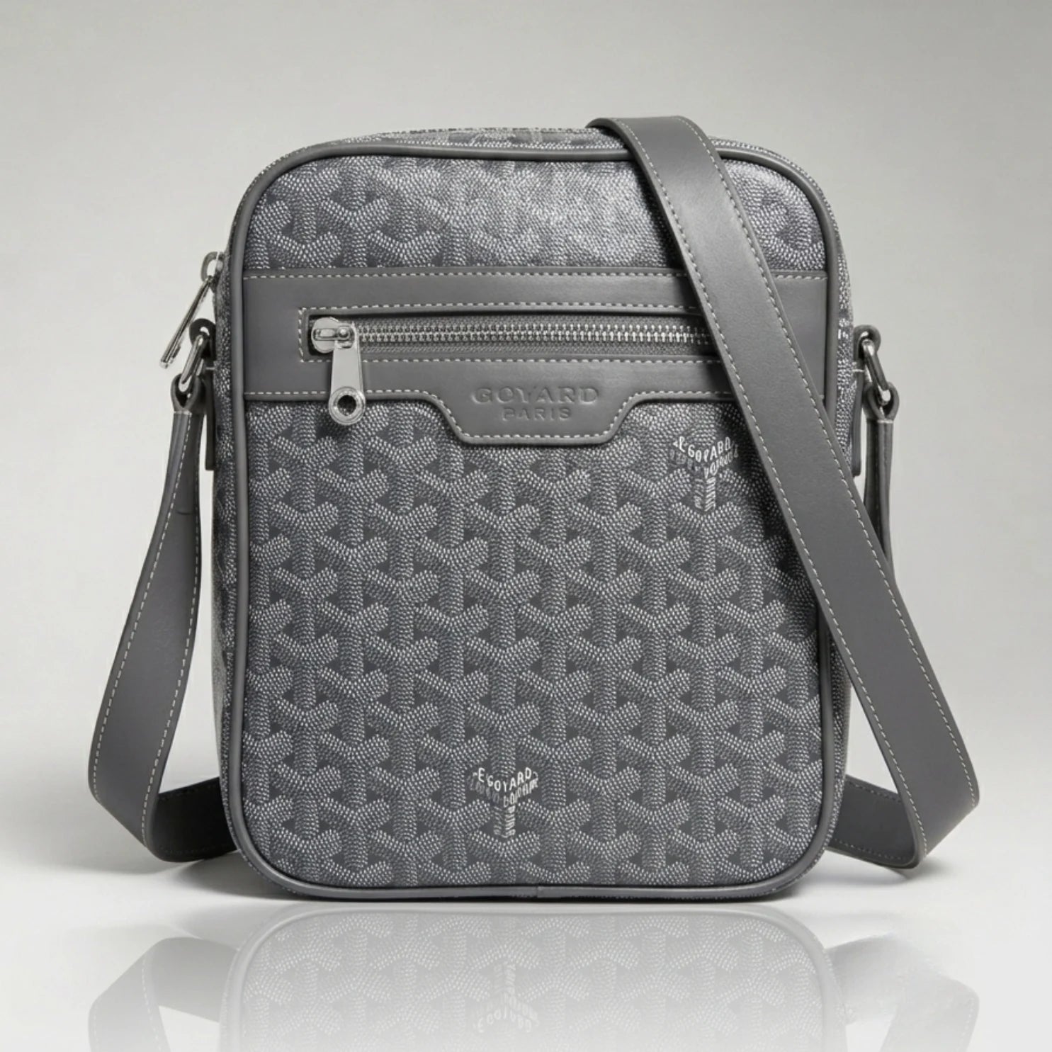 Goyard grey Goyardine canvas crossbody bag with front zip pocket and adjustable strap.