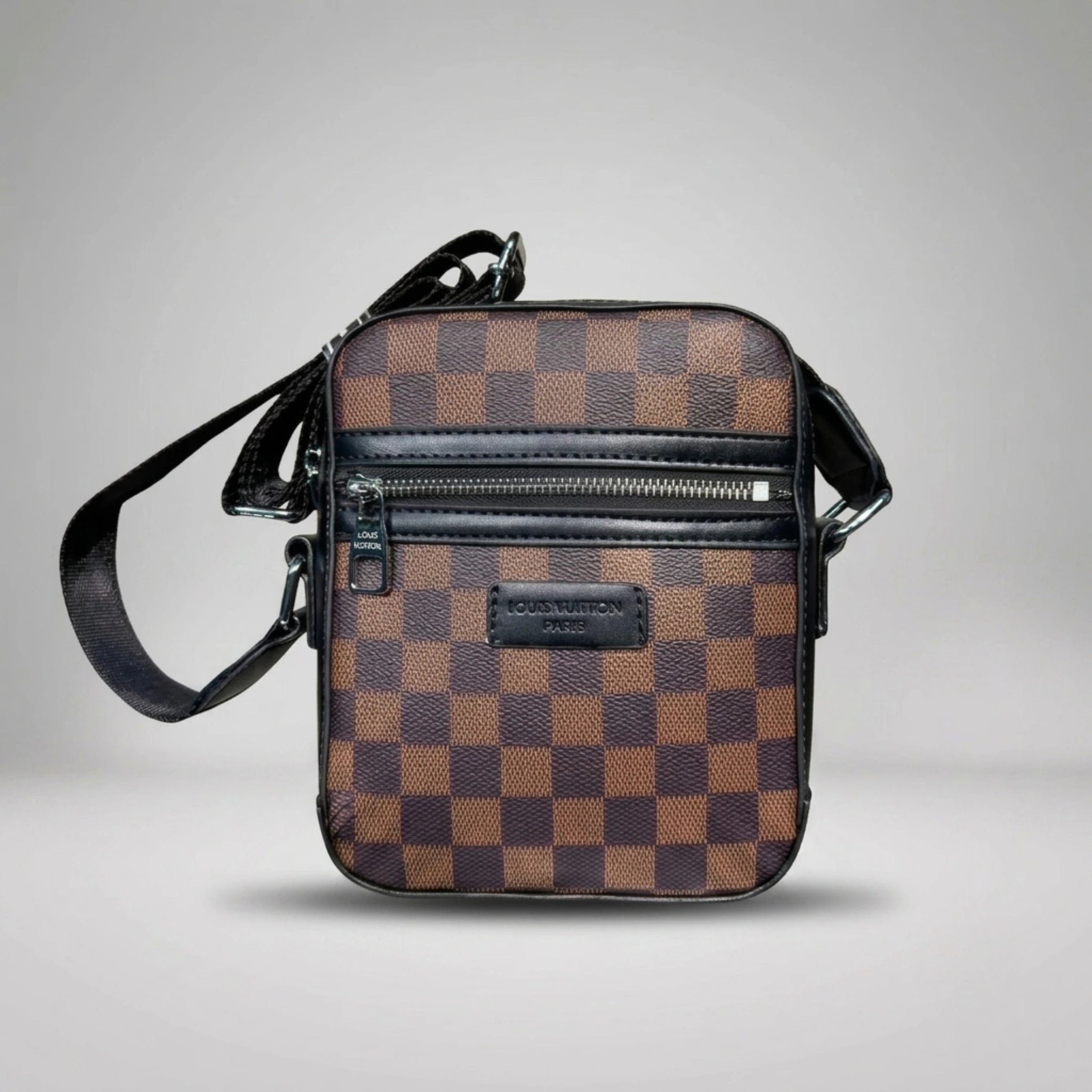 Louis Vuitton brown Damier Ebene canvas crossbody bag with front zip pocket and shoulder strap.