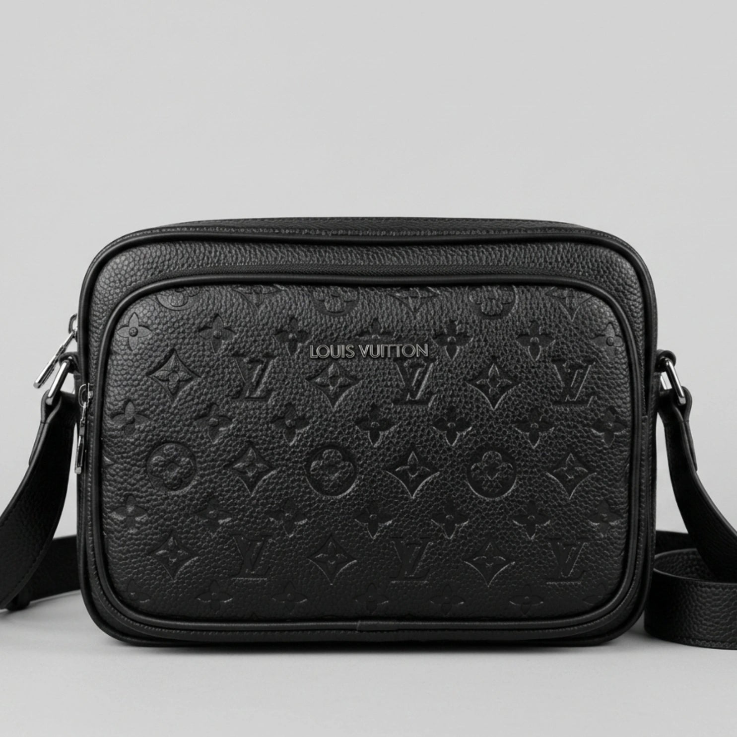 Louis Vuitton black Monogram Empreinte leather camera bag with front zip pocket and shoulder strap.