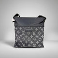 Louis Vuitton grey Monogram denim flat crossbody bag with black top panel and leather logo patch.