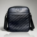 prada black monogram embossed leather crossbody bag with an adjustable strap.