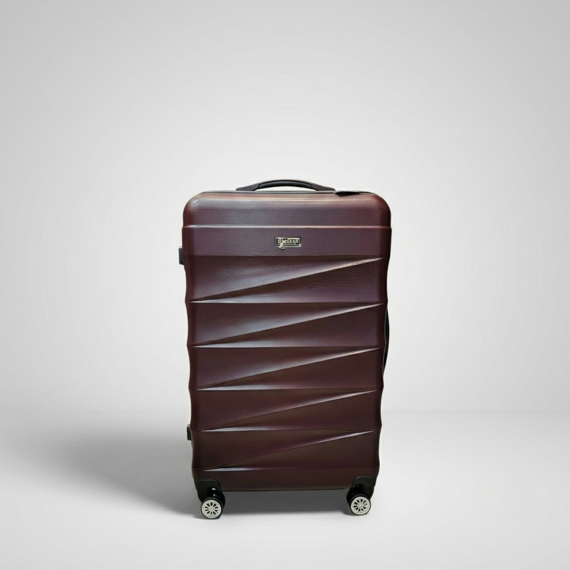 Unicare burgundy textured hard shell spinner trolley bag with geometric diagonal grooves.