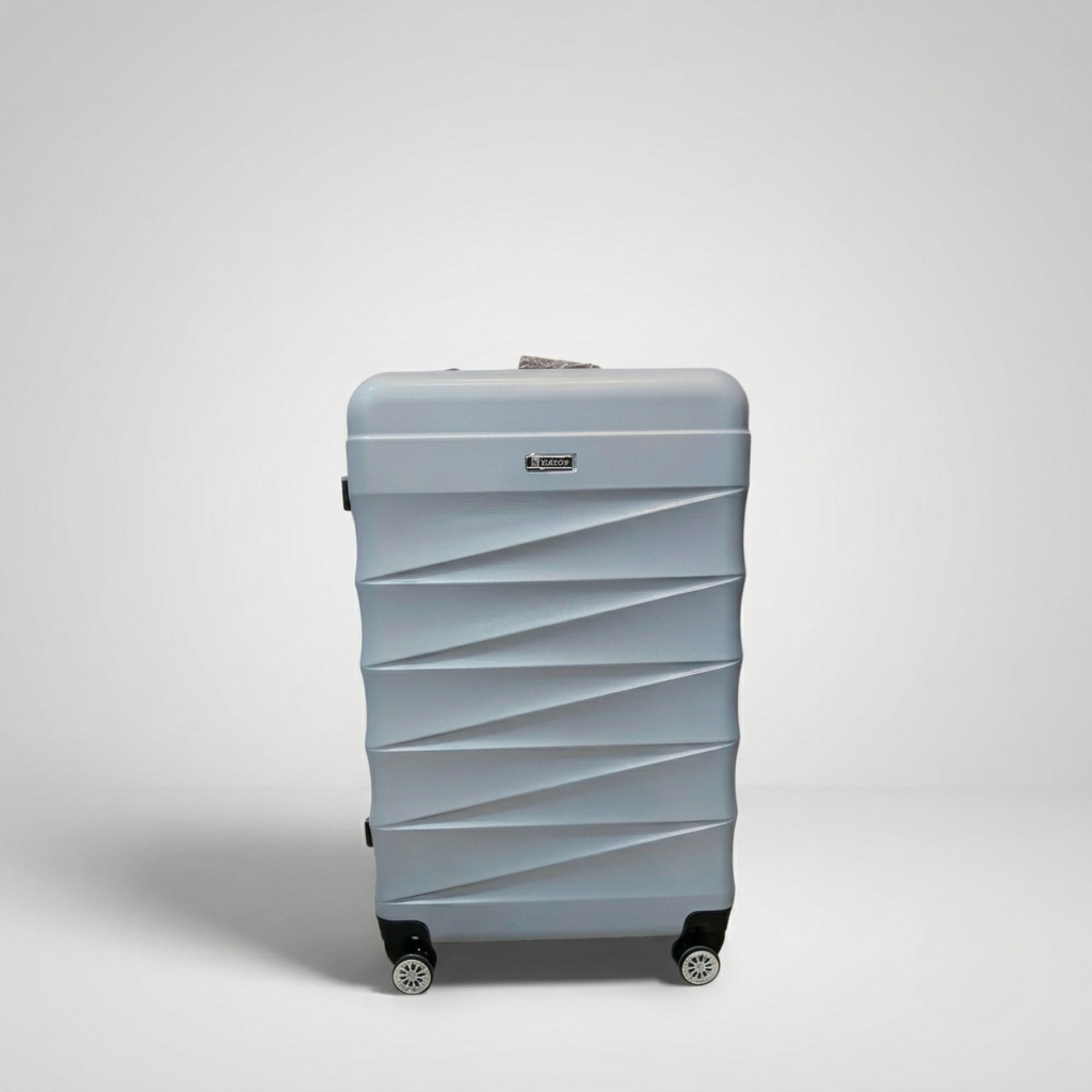 Unicare burgundy textured hard shell spinner trolley bag with geometric diagonal grooves.